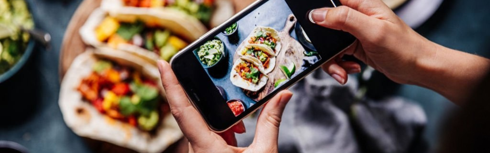 Person taking a photo of food with a smartphone