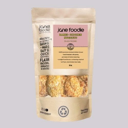 Jane Foodie Baked Chicken Nuggets in resealable pouch, flash frozen for easy heat-and-eat meals, shown in clear window packaging.