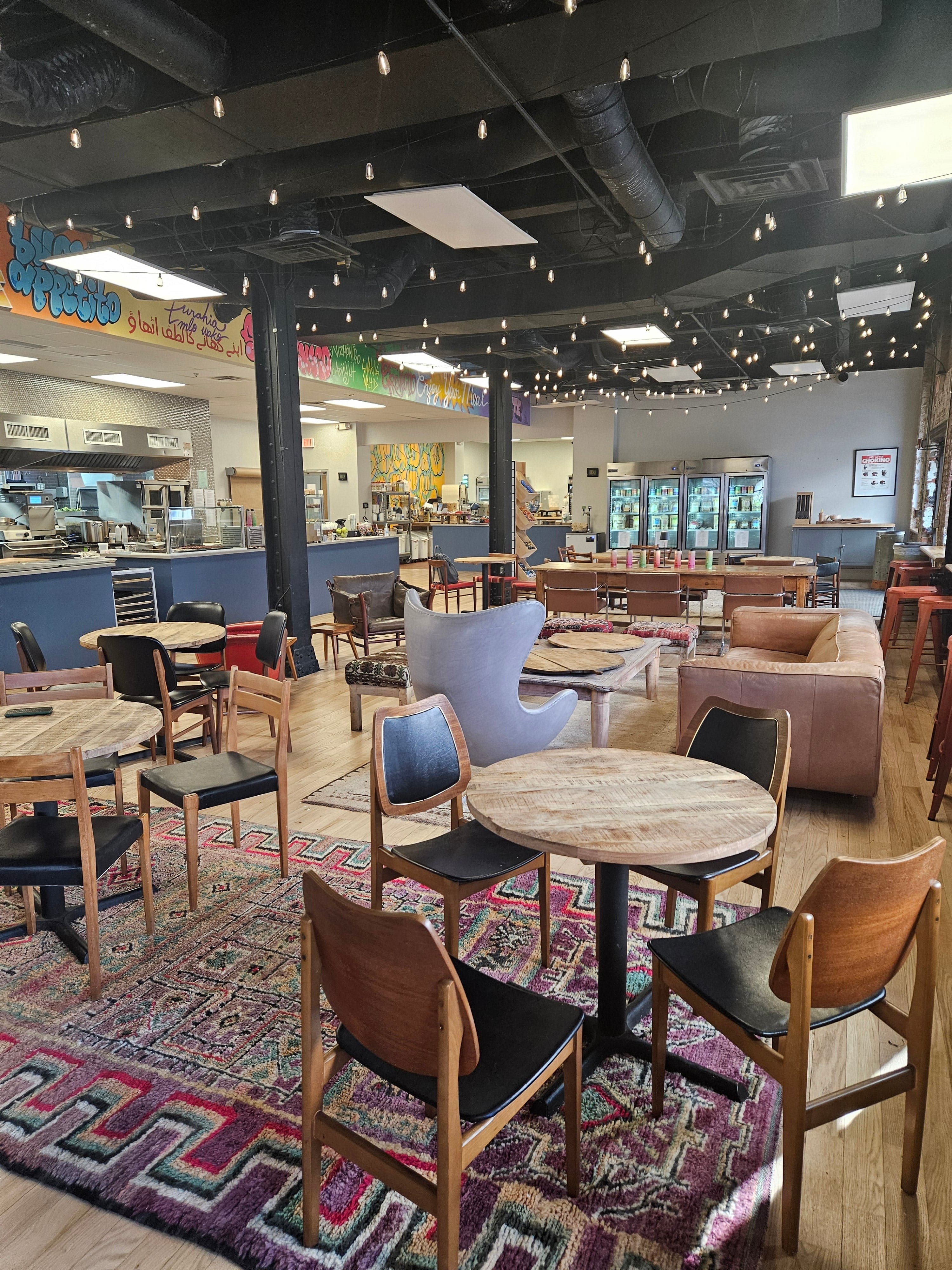 Interior of a store with furniture on display, including chairs and tables.