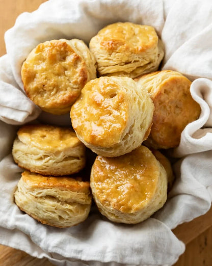 Basket of golden-brown biscuits with a white cloth lining
