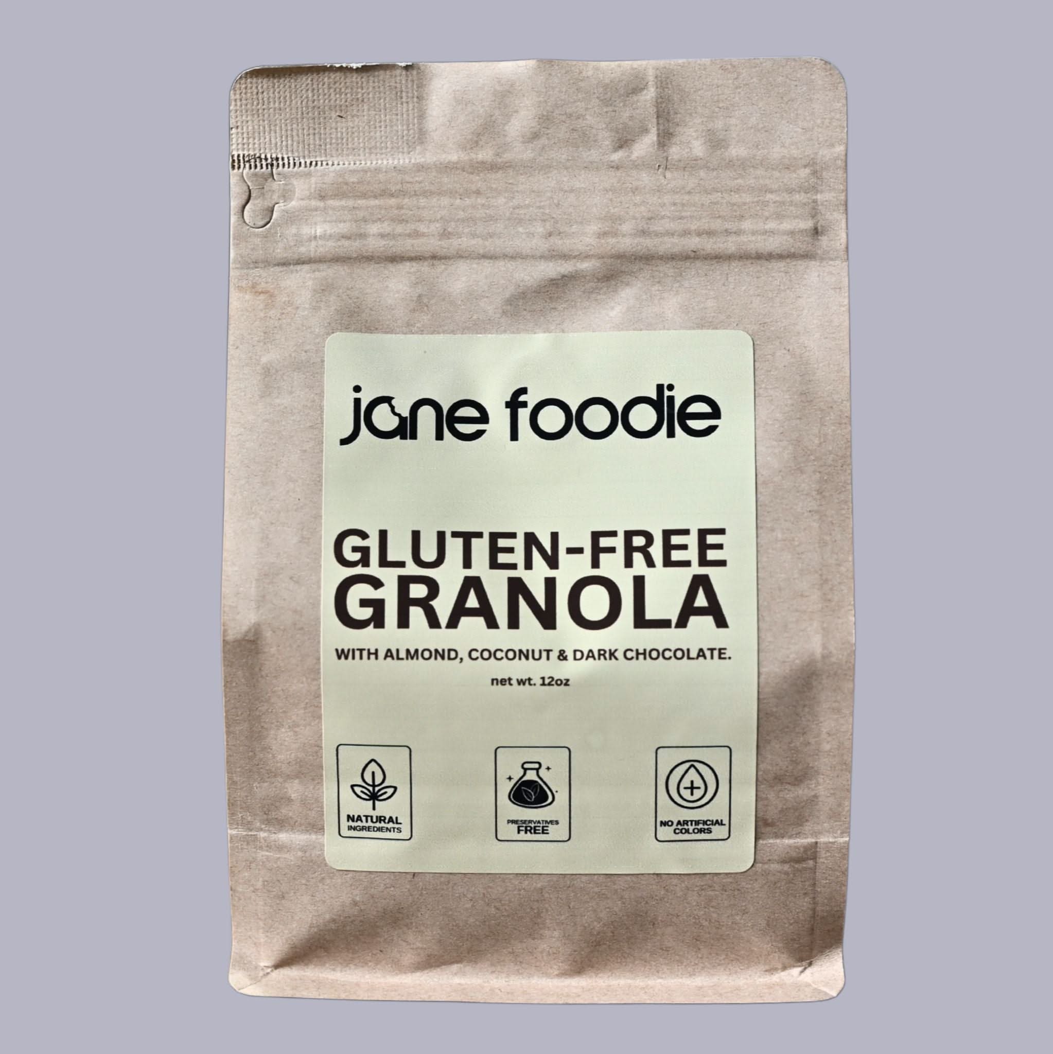 Front of Jane Foodie Gluten-Free Granola 12 oz pouch with almond, coconut, and dark chocolate, labeled natural, and preservative-free.