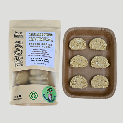 Gluten-free oatmeal frozen cookie dough pucks in clear packaging with kraft baking tray on white background