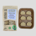 Gluten-free oatmeal frozen cookie dough pucks in clear packaging with kraft baking tray on white background