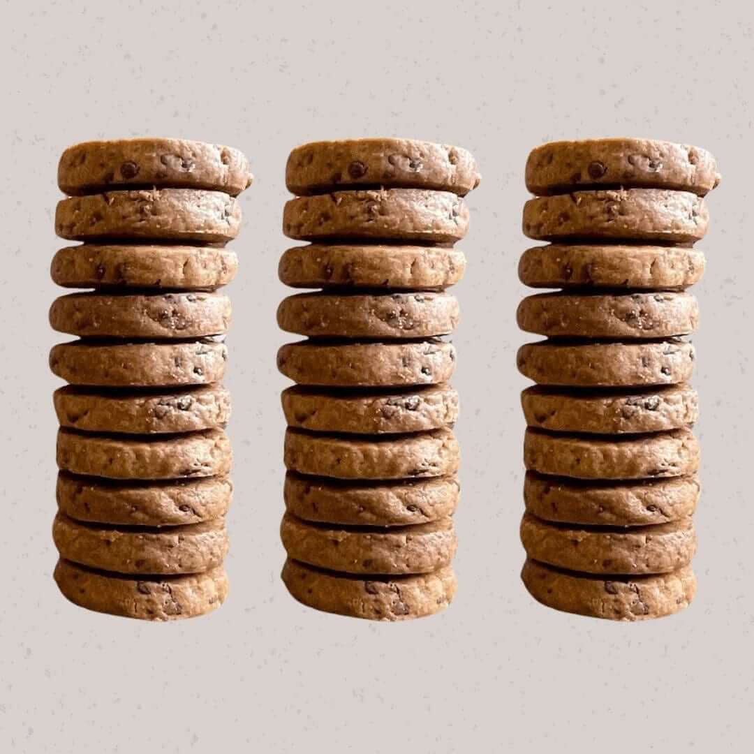 Three stacks of chocolate chip cookies made with dark chocolate and rye flour, topped with sea salt, showcasing Jane Bakes' natural ingredients.