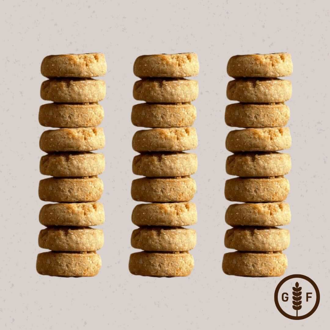 Gluten-free oatmeal cookies stacked in bulk pack, healthy snack with low sugar and high fiber, Jane Bakes logo.