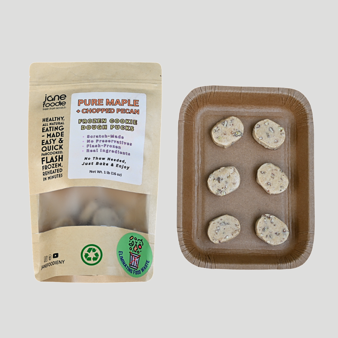 Maple pecan frozen cookie dough pucks in kraft packaging with baking tray on light gray background